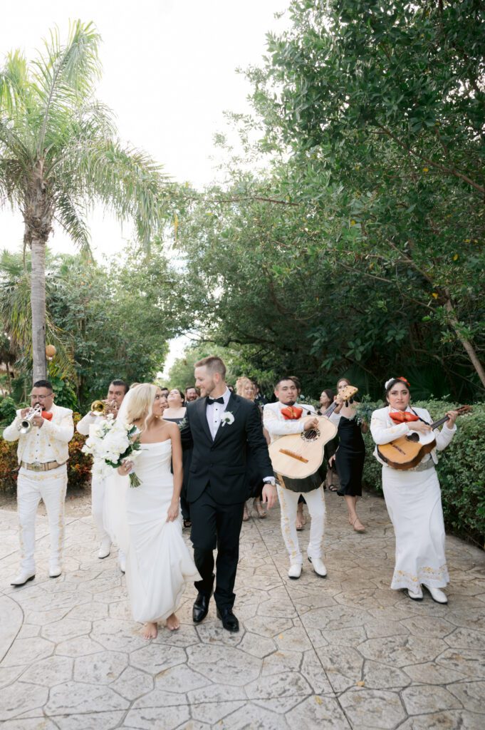 Mariachi leading wedding march through the resort